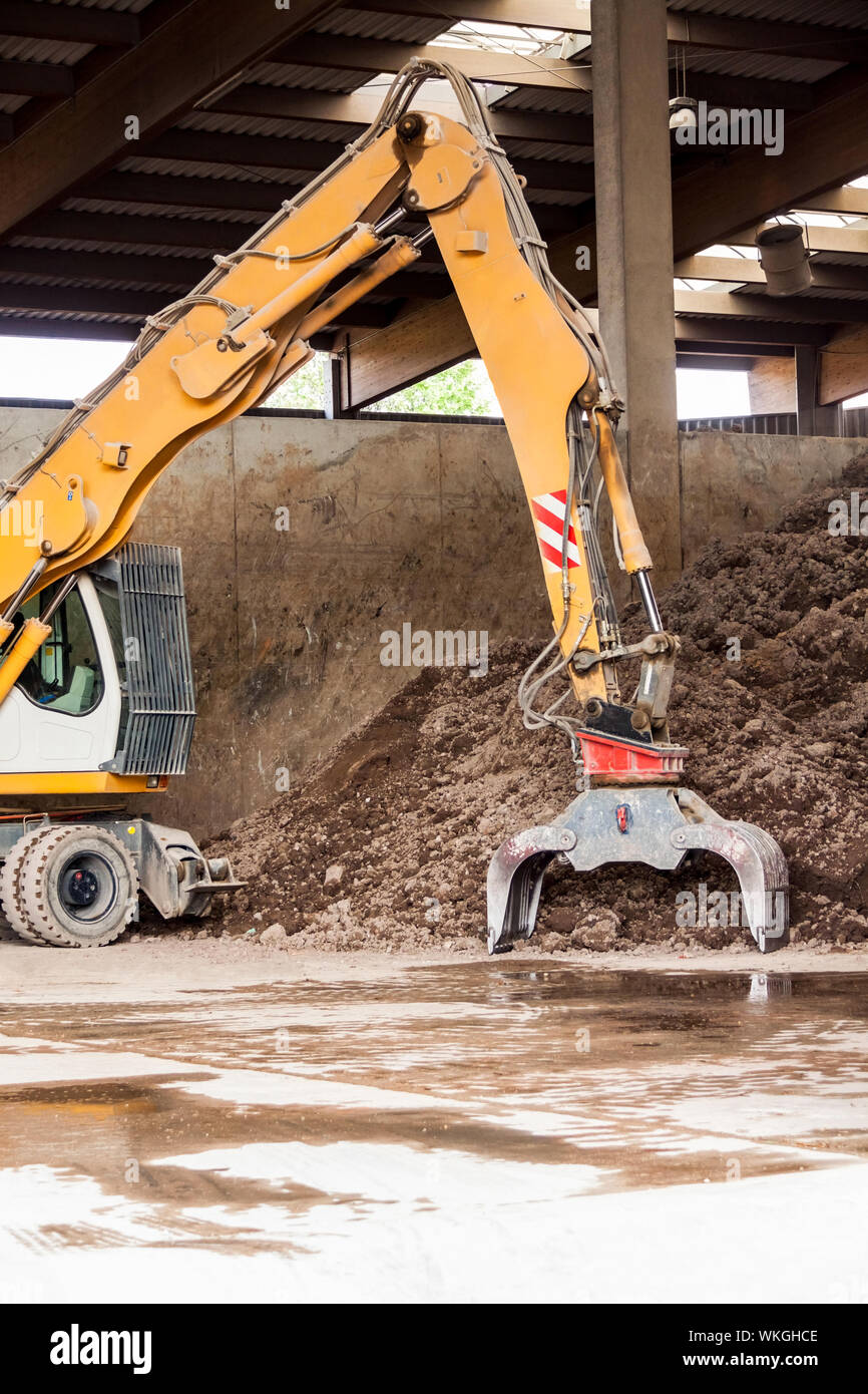 Heavy duty excavator doing earth moving parked undercover in an open