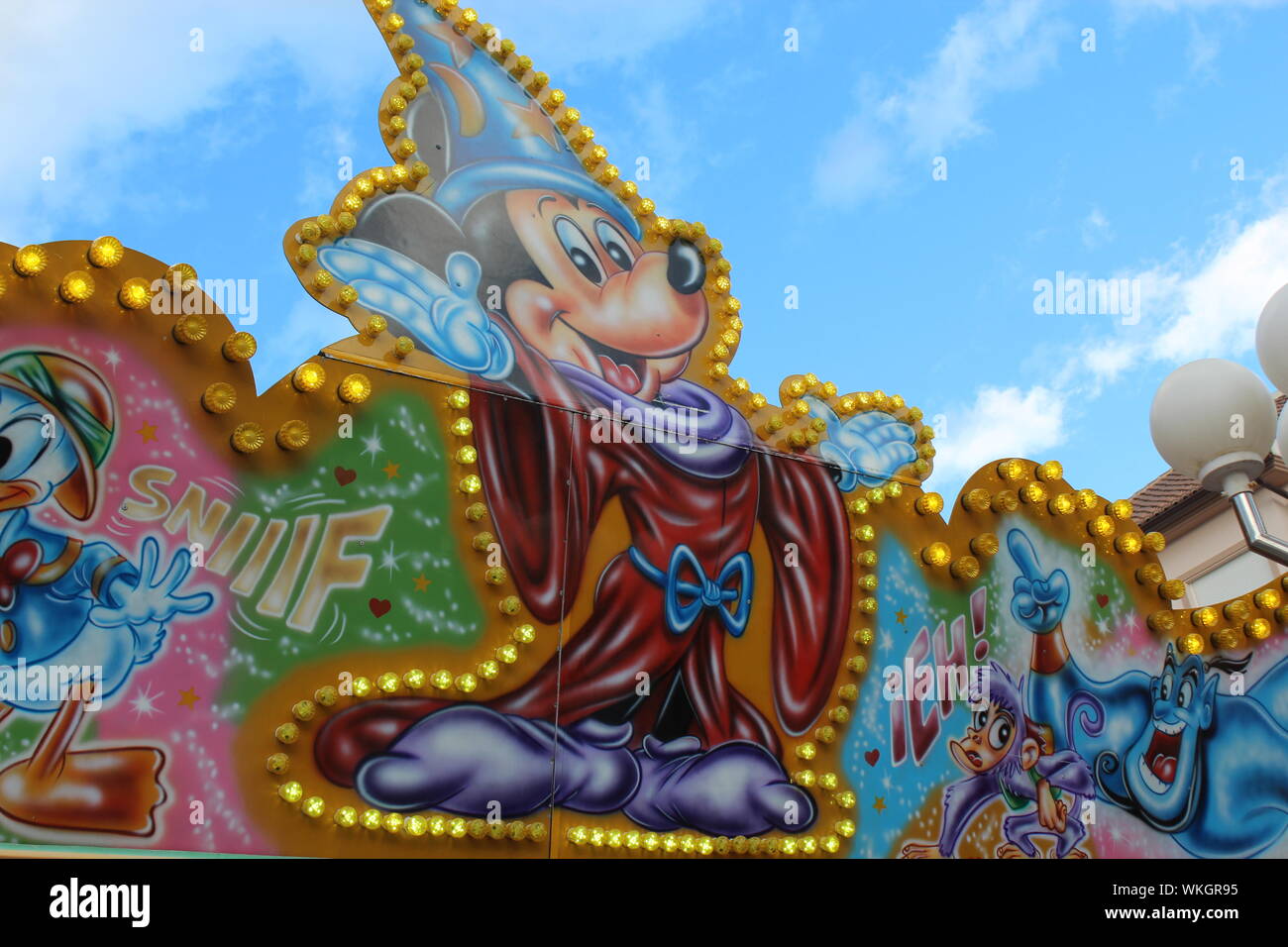 Disney characters on rides at a carnival in Gandia, Spain during Las Fallas. Stock Photo