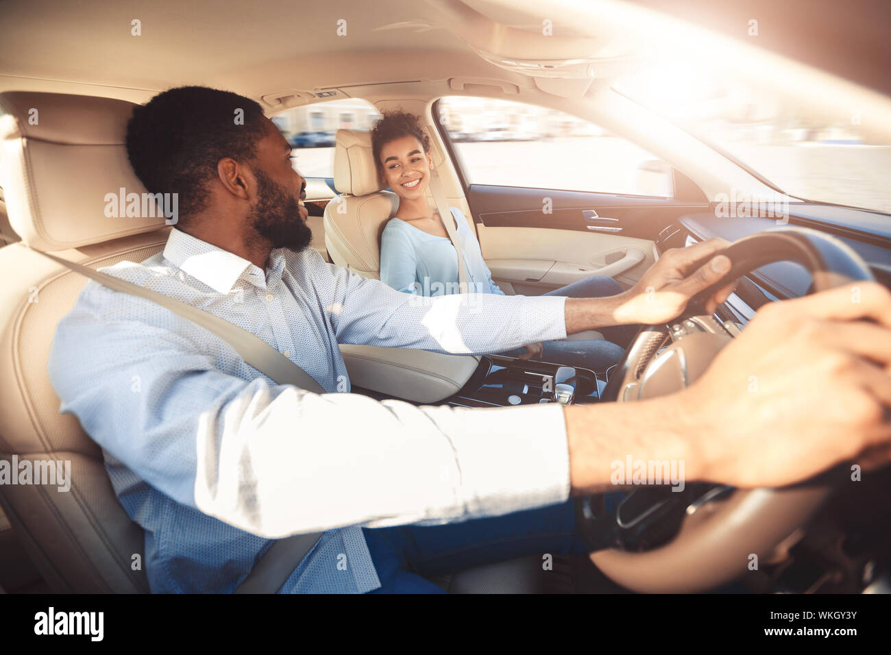 Test drive. Happy couple talking in car Stock Photo