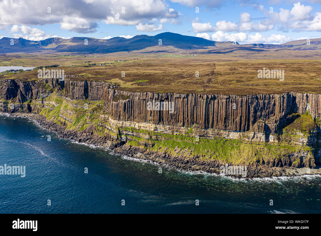 An aerial view of Kilt Rock with mountains in the background. Kilt Rock is made of Basalt columns on a base of sandstone. Its location is on the North Stock Photo