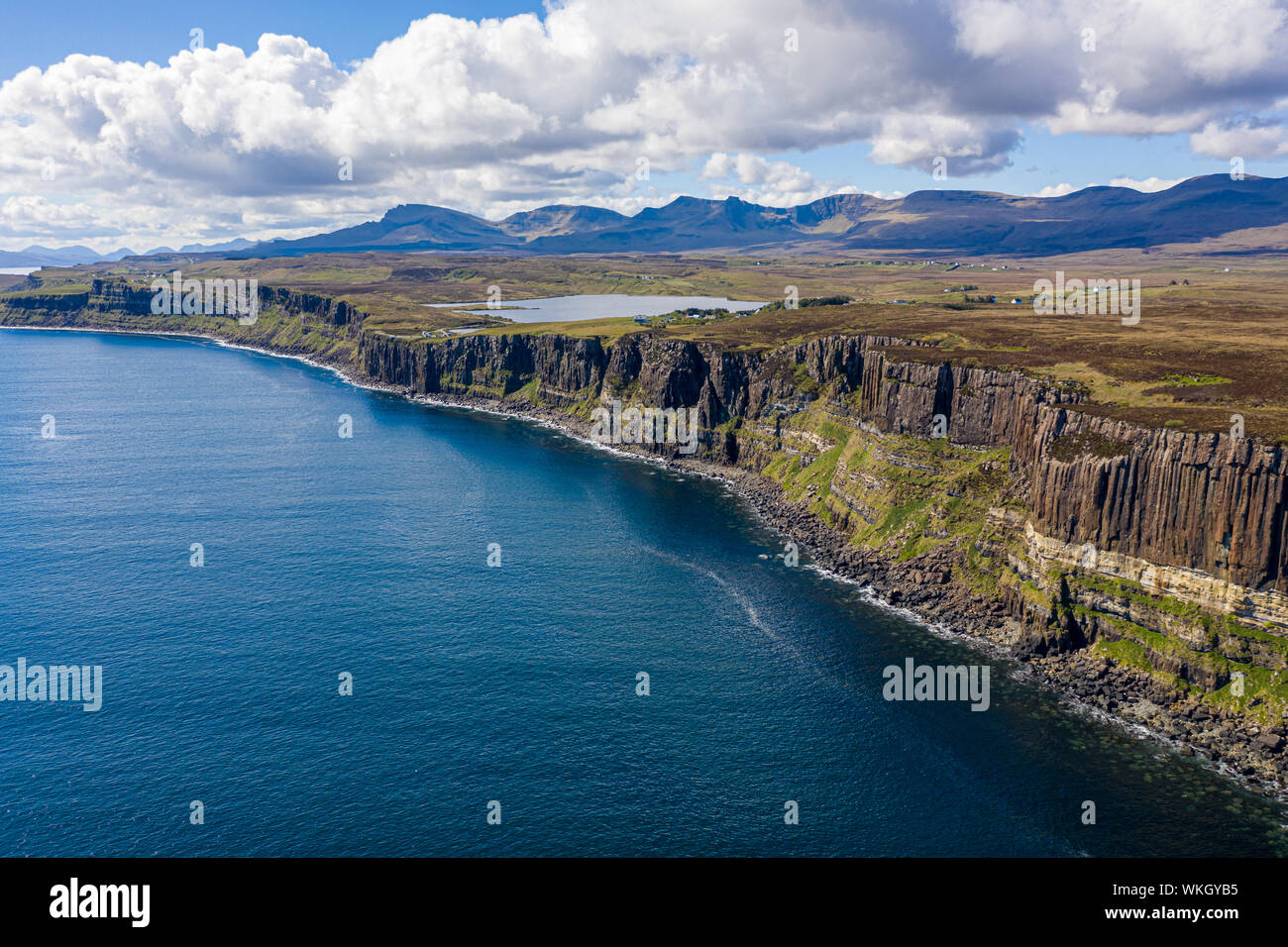 An aerial view of Kilt Rock with mountains in the background. Kilt Rock is made of Basalt columns on a base of sandstone. Its location is on the North Stock Photo