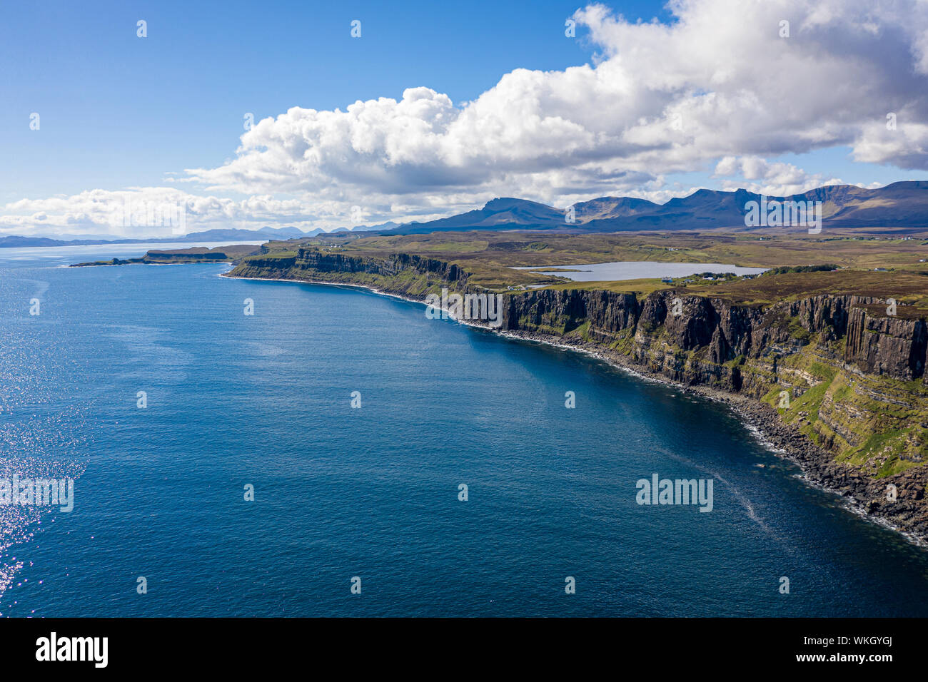 An aerial view of Kilt Rock with mountains in the background. Kilt Rock is made of Basalt columns on a base of sandstone. Its location is on the North Stock Photo