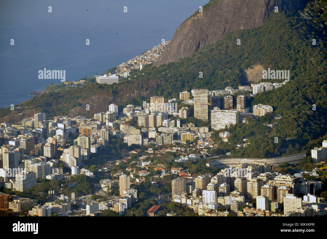 Scenic View Of Houses By Mountain At Morro Dois Irmaos Against Sea Stock Photo