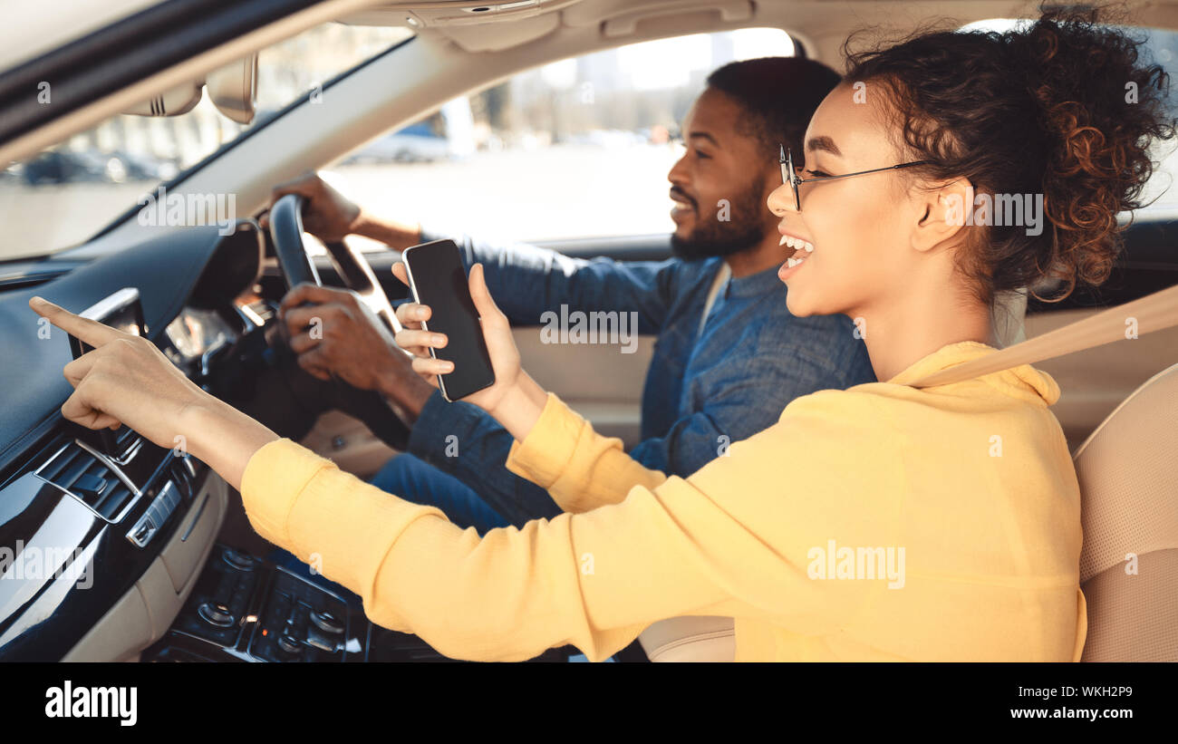 Afro couple driving car and using gps navigator Stock Photo