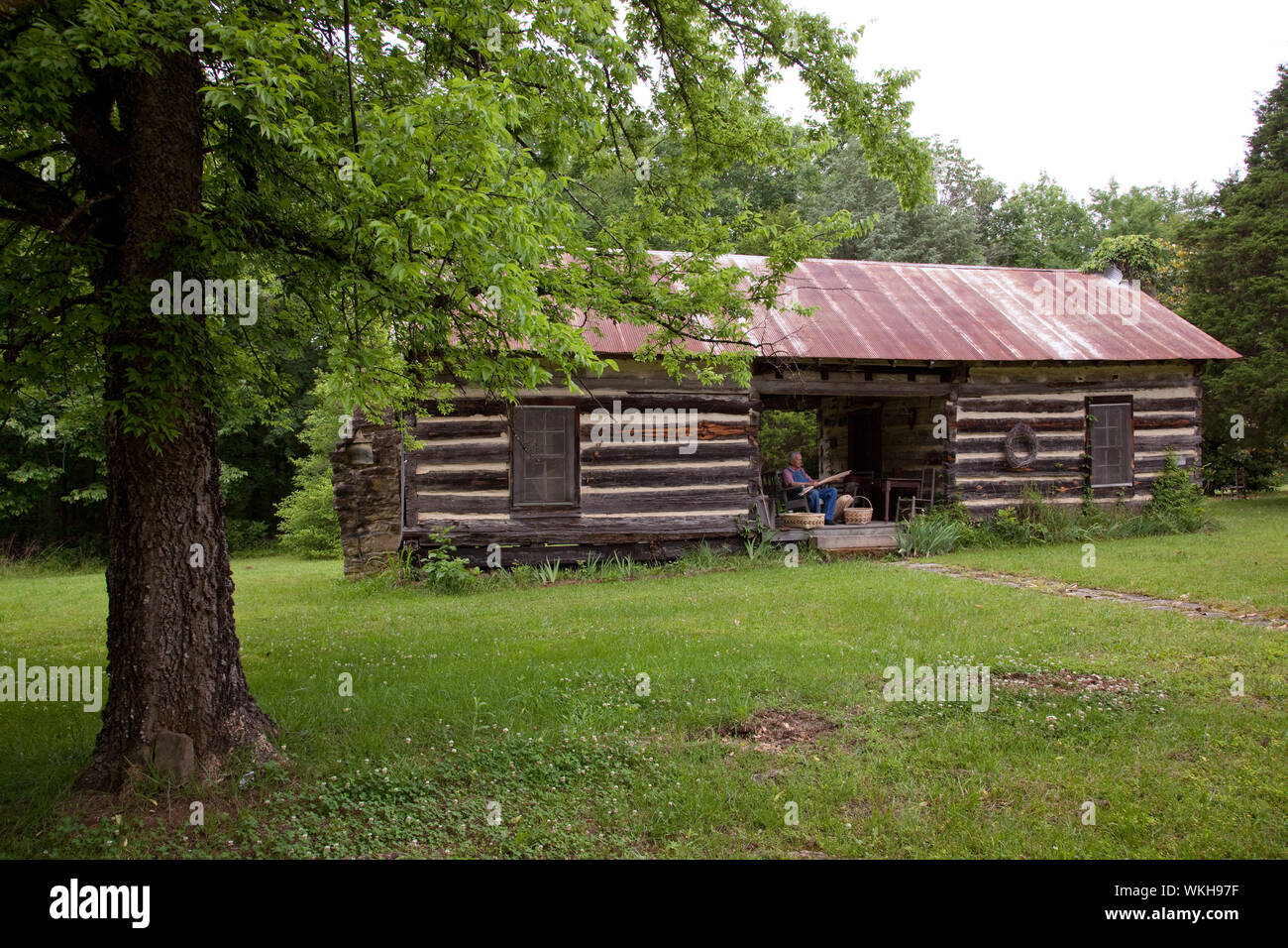 John Herbert weaves baskets in a dogtrot log cabin, Cherokee, Alabama