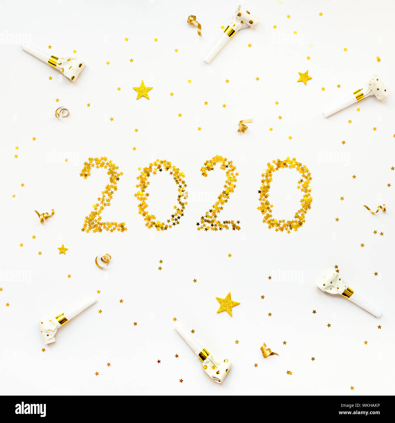New 2020 Year golden star shaped confetti celebration background. Stock Photo