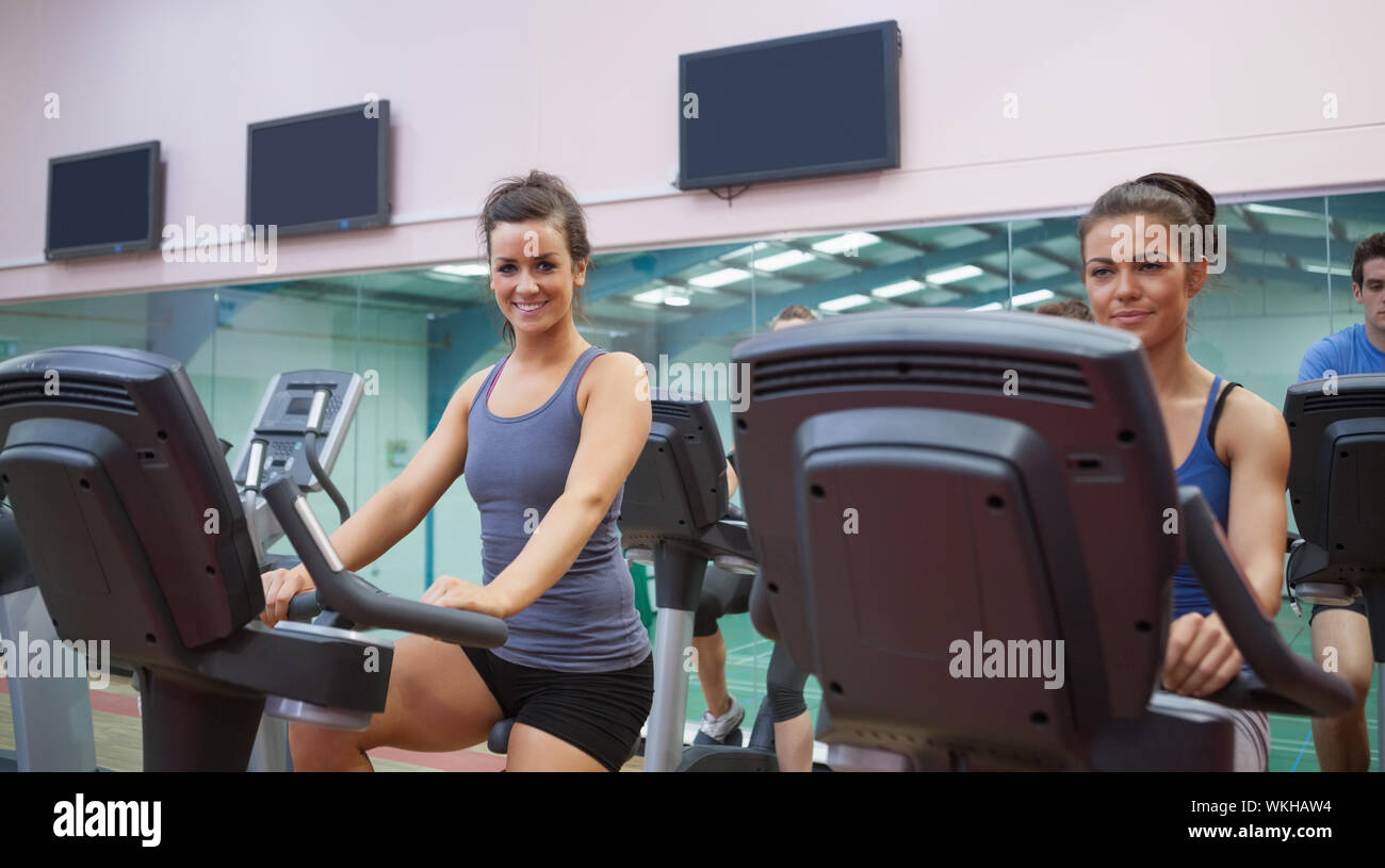 Two women at spinning class in gym Stock Photo - Alamy