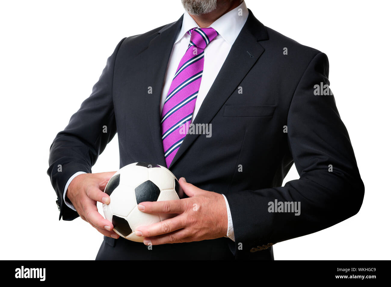 Business man in dark suit and tie holds a soccer ball Stock Photo - Alamy