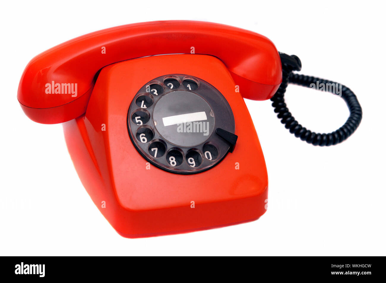Close-up Of Red Telephone Against White Background Stock Photo