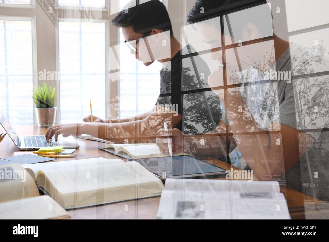 man studying design lesson with graphic tablet. college student learning online taking note Stock Photo