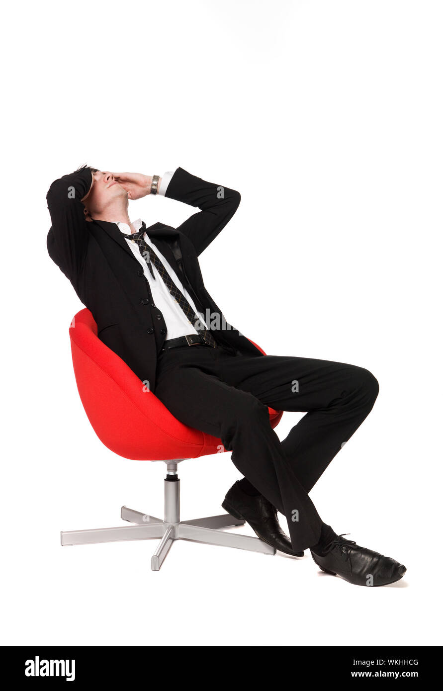 Man in red armchair Stock Photo