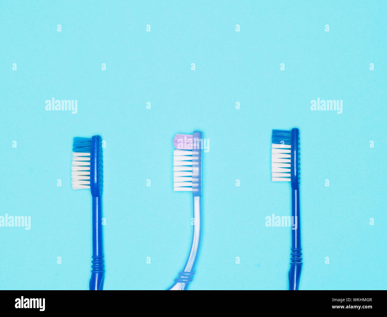 Toothbrushes on blue background. Dental care concept Stock Photo