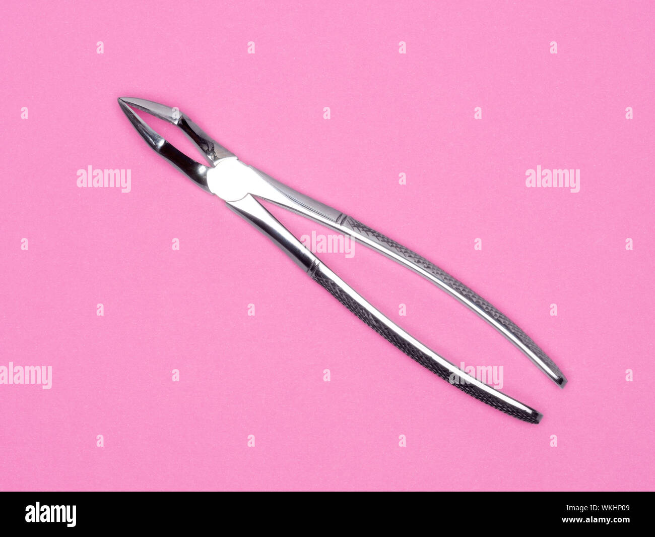 Dental surgical instrument on pink background. Dental care concept