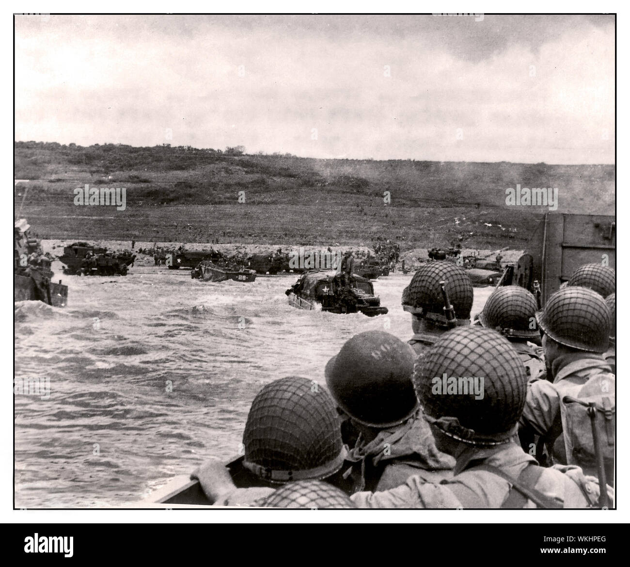 D-Day WW2 JUNE 6th 1944 American GI Soldiers group in a pitching landing craft ready to beach under fire by Nazi Wehrmacht gun emplacements at Normandy France during the Allied invasion, June 6, 1944. Along a 50-mile stretch of coastline in northern France, more than 160,000 Allied troops stormed Utah Beach and four other beaches that day to gain a foothold in continental Nazi Europe. By the end of the D-Day invasion, more than 9,000 of those Allied troops were either dead or wounded -- the majority of them Americans. World War II Second World War Normandy France Stock Photo