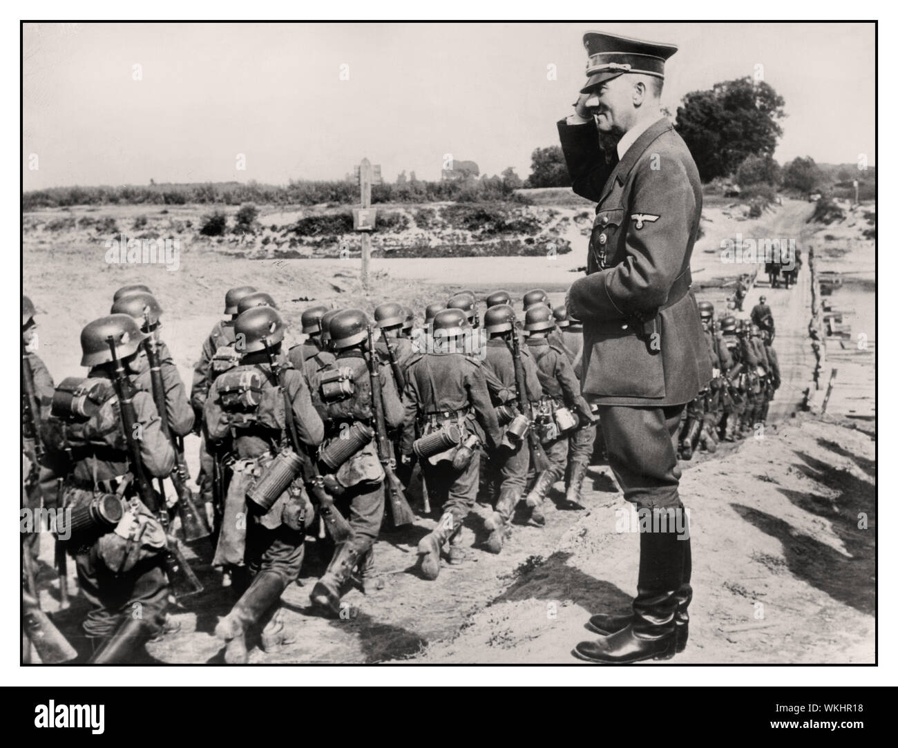 1939 ADOLF HITLER SALUTE GERMAN INVASION OCCUPATION  POLAND Adolf Hitler saluting advancing marching invasion WW2 image of German Wehrmacht  soldiers troops during occupation of Poland WW2 Stock Photo