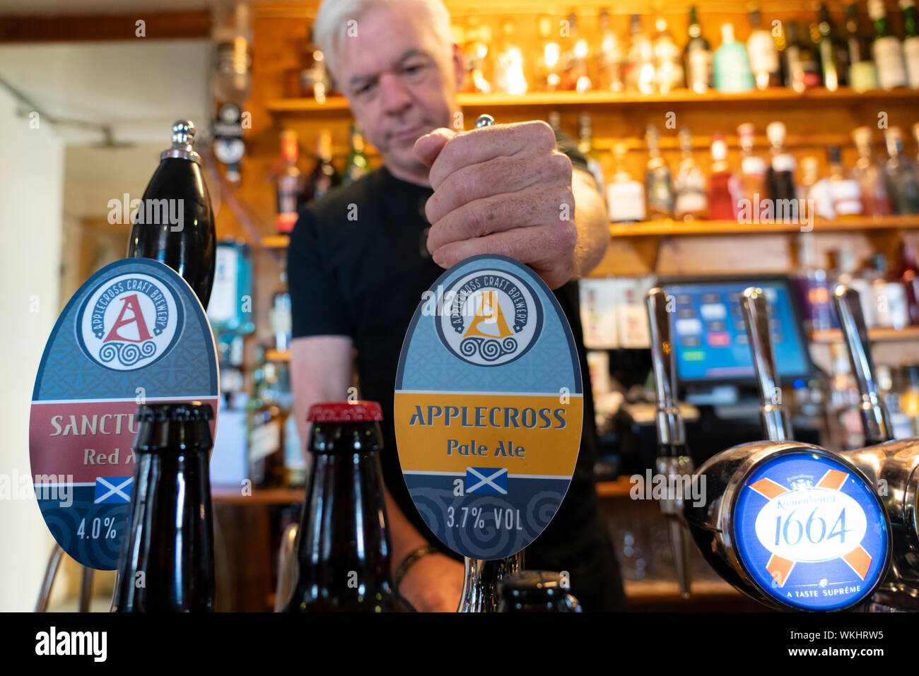 Barman in the Applecross Inn on the North Coast 500 tourist motoring route in northern Scotland, UK Stock Photo