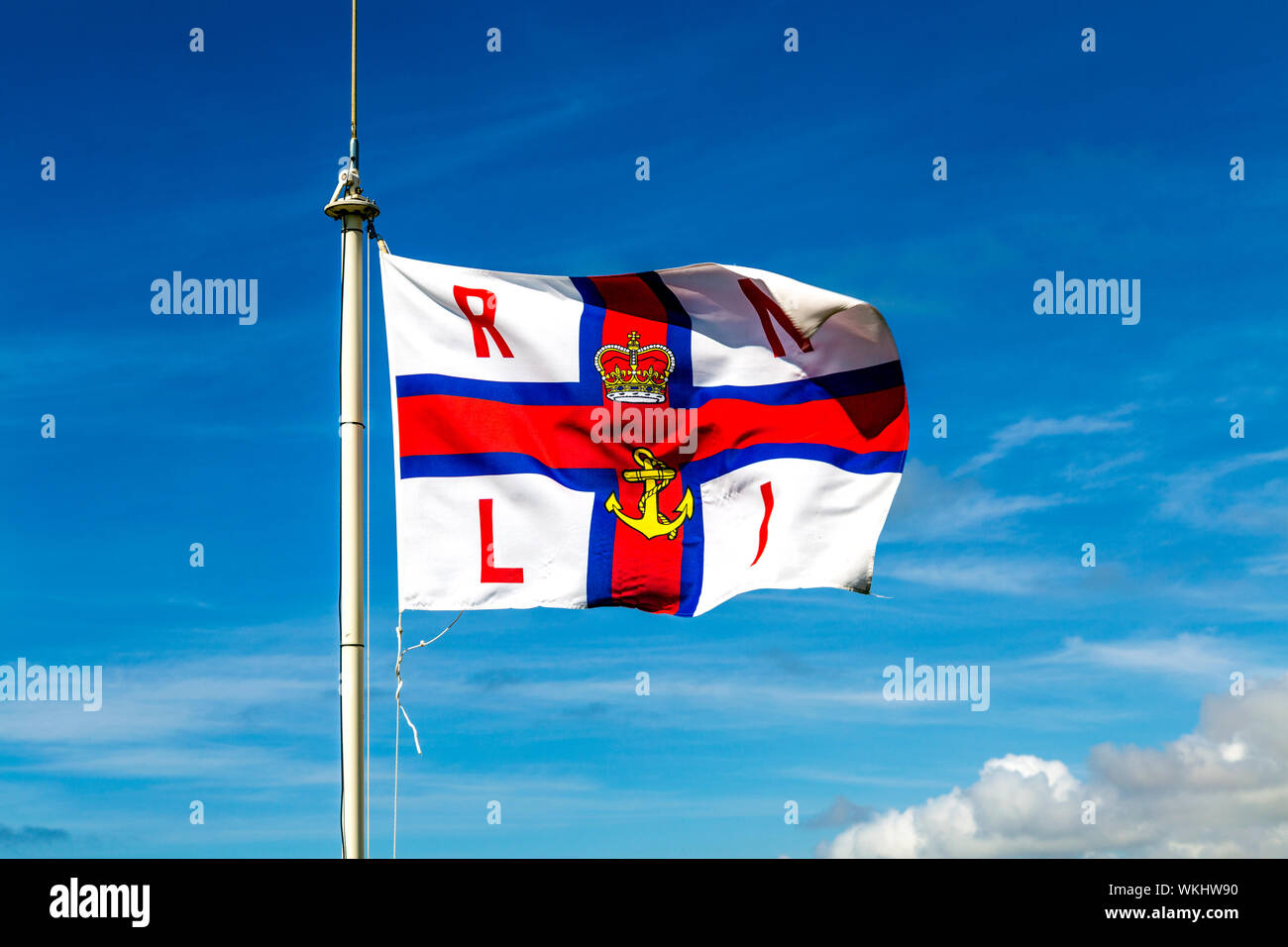 RNLI (Royal National Lifeboat Institution) flag fluttering in the wind Stock Photo