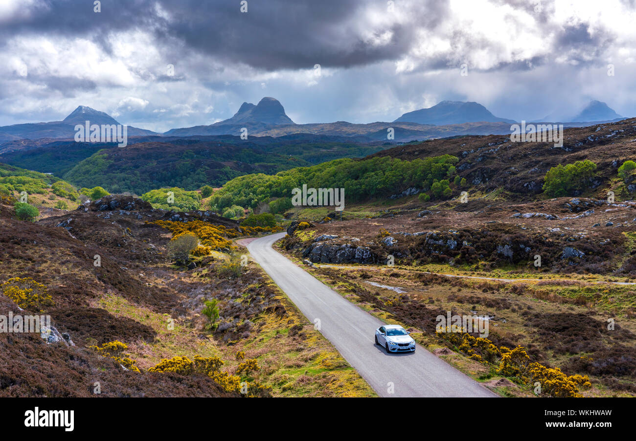 Car driving on the North Coast 500 tourist motoring route near Lochinver, , Assynt, Sutherland, Scotland Stock Photo