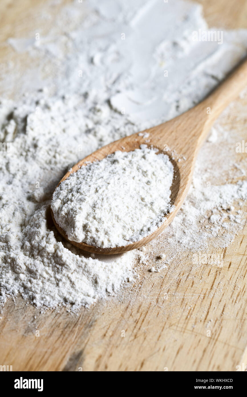 flour in a wooden spoon on a cutting board Stock Photo - Alamy