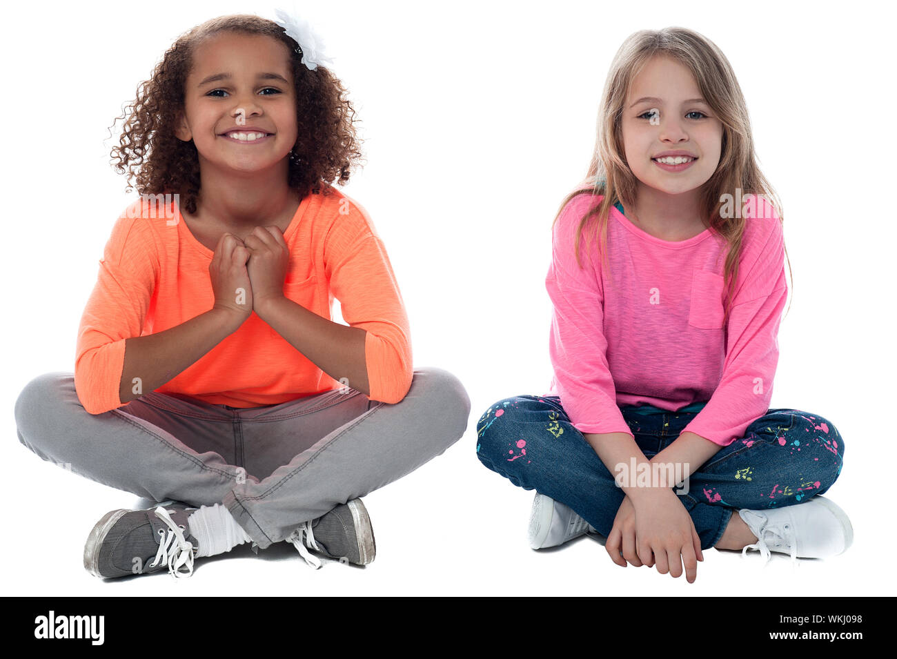Pretty girls sitting on the floor and playing Stock Photo - Alamy