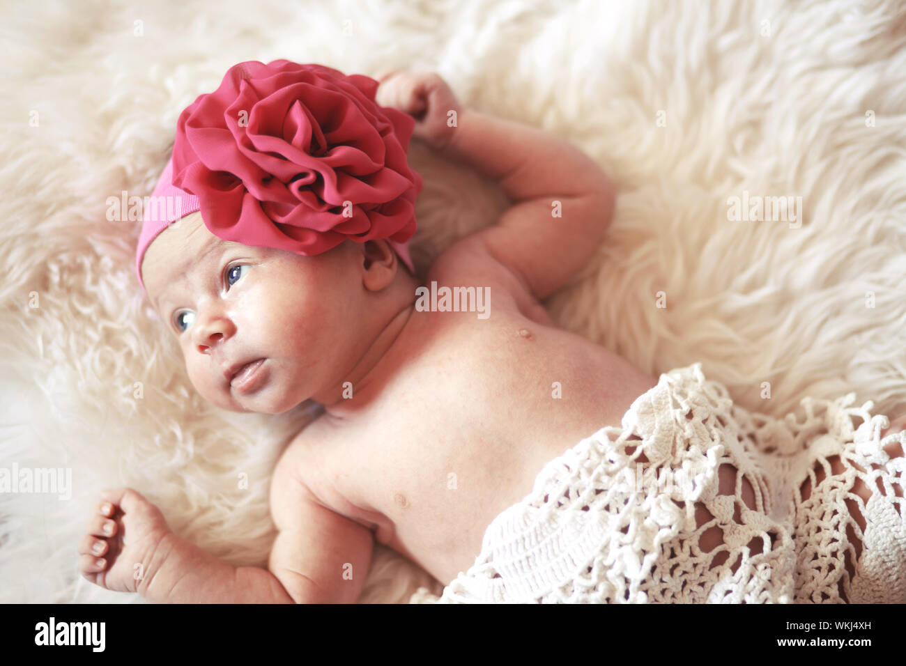 Portrait of a cute newborn baby girl lying down on a blanket Stock ...
