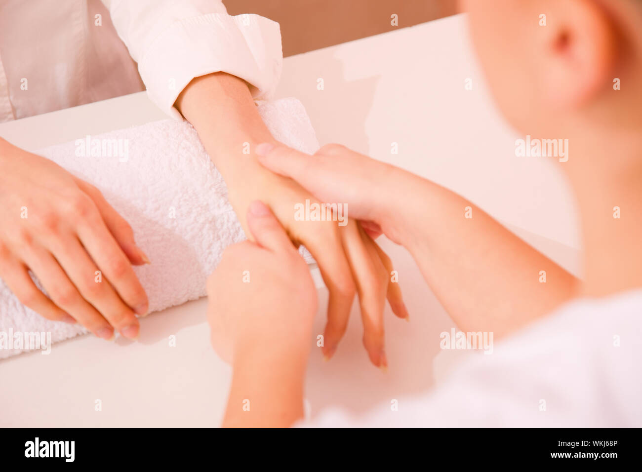 Masseuse massaging hand Stock Photo