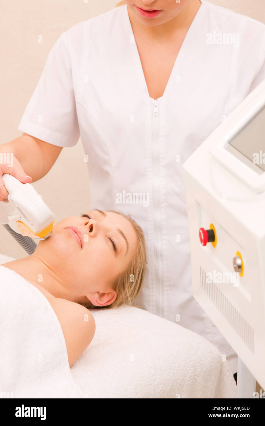 Woman getting light pulsed hair removal treatment Stock Photo