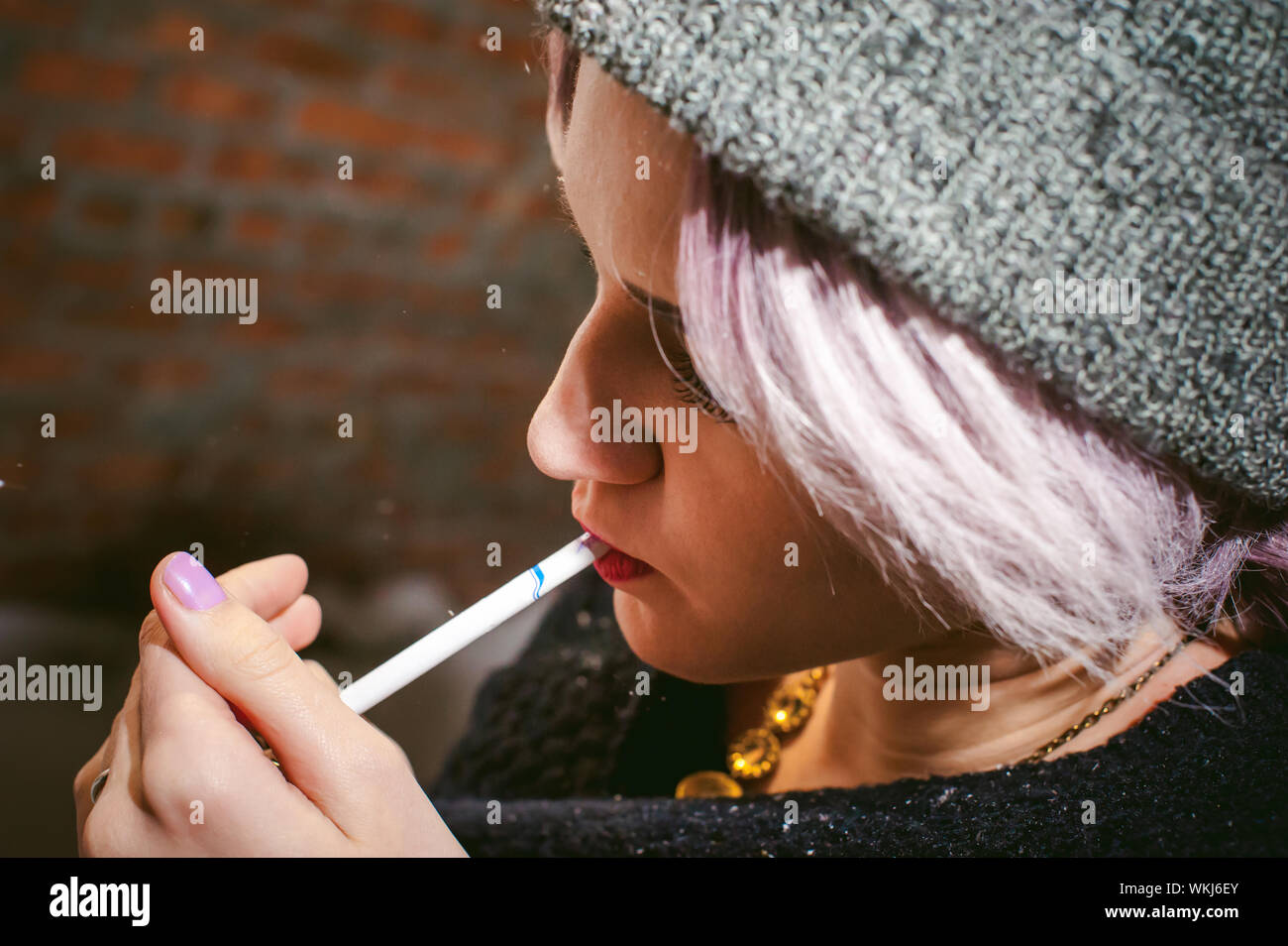 Woman lighting cigarette hires stock photography and images Alamy