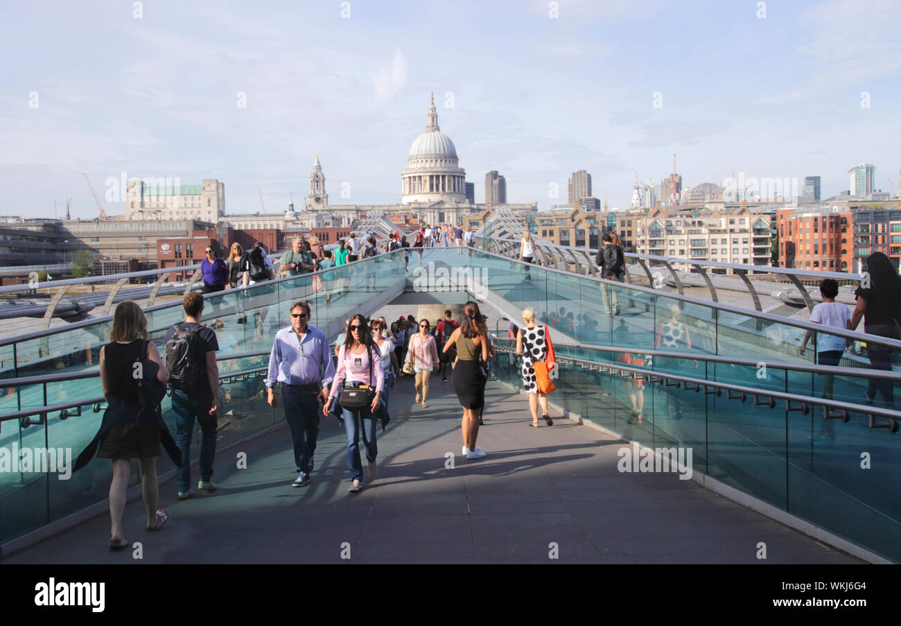 People walking across Millennium Bridge London summer 2019 Stock Photo