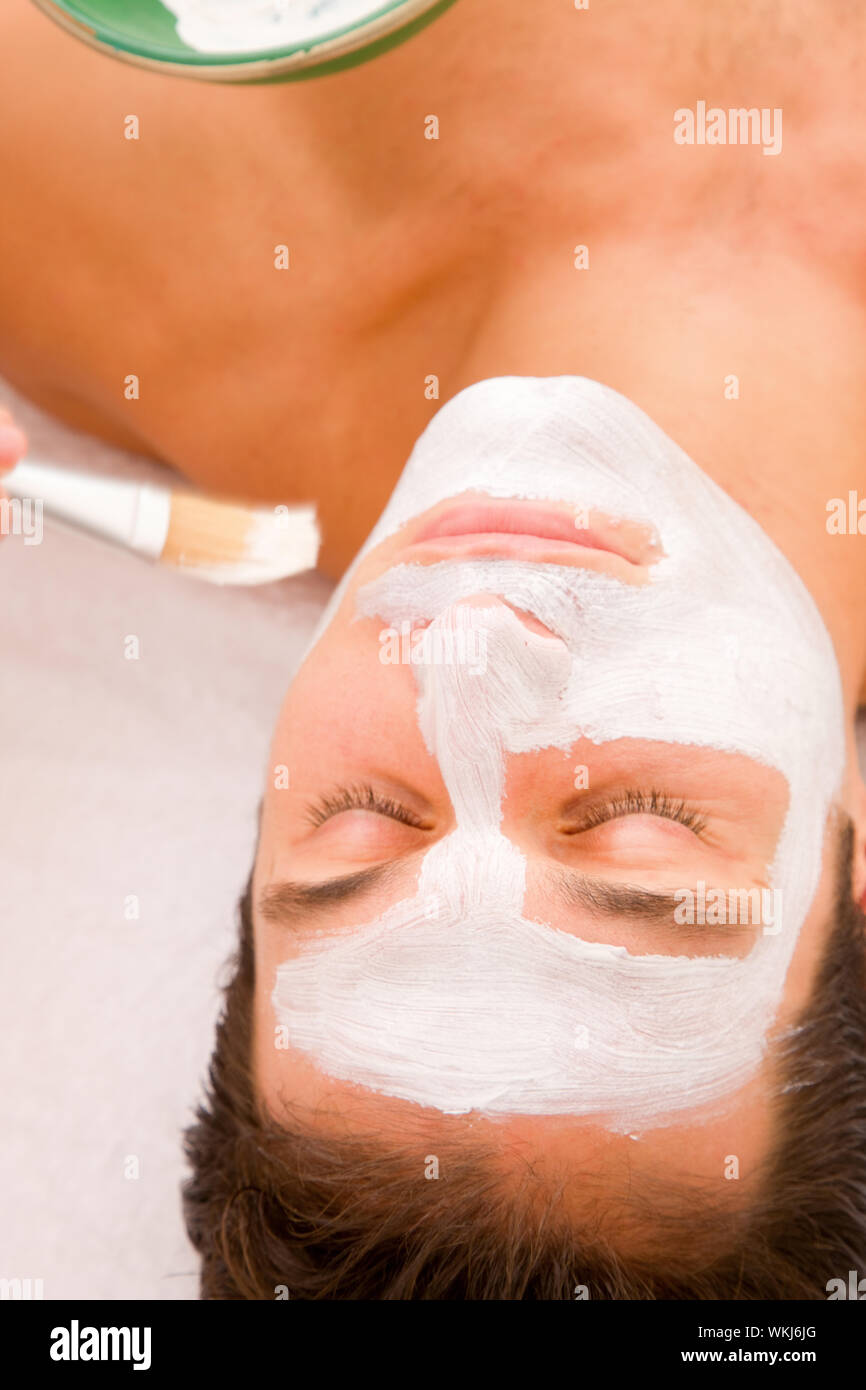 Young man having facial spa treatment Stock Photo