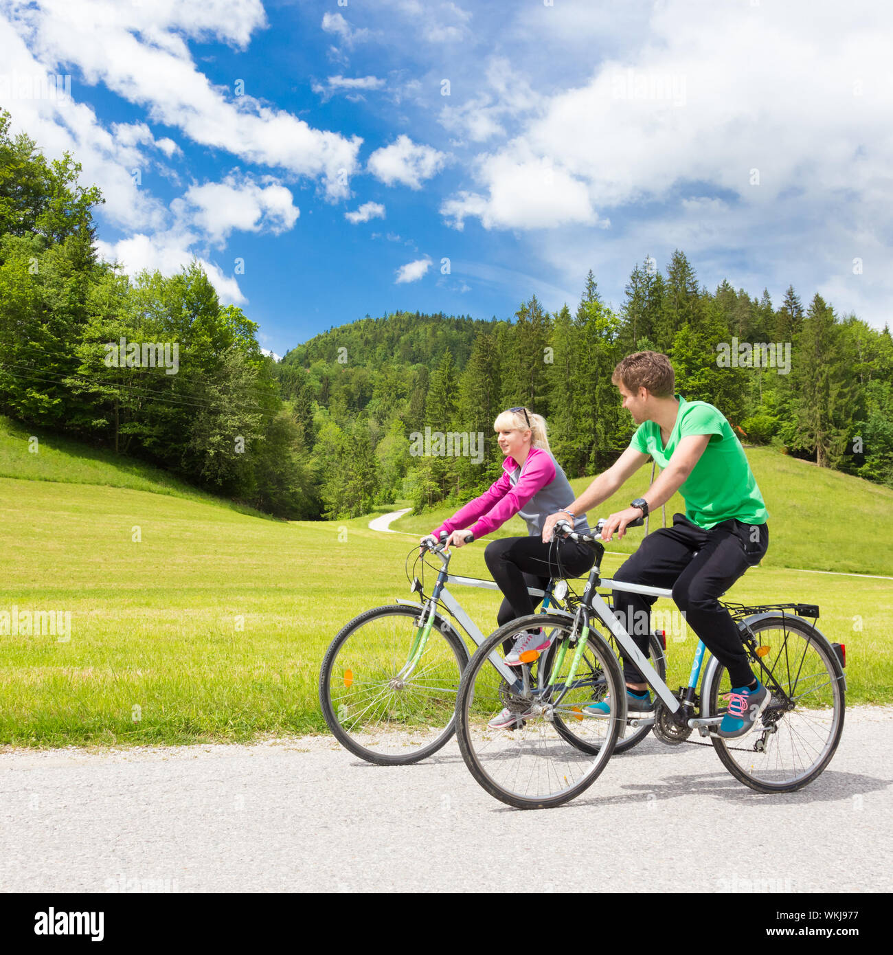 Young spoty active cople biking in nature. Active lifestyle. Activities