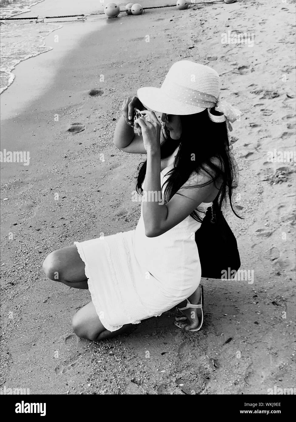 Woman Sand Kneeling Black and White Stock Photos & Images - Alamy