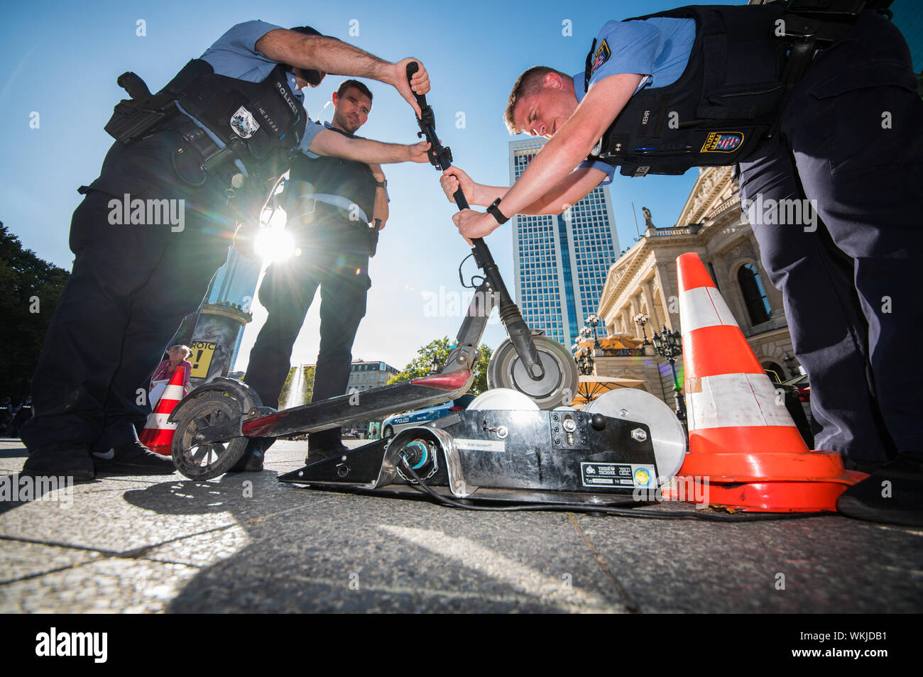 04 September 2019, Hessen, Frankfurt/Main: Police officers check an  e-scooter at a police check on the chassis dynamometer. Police officers  check e-scooters in front of the Alte Oper. According to police reports,