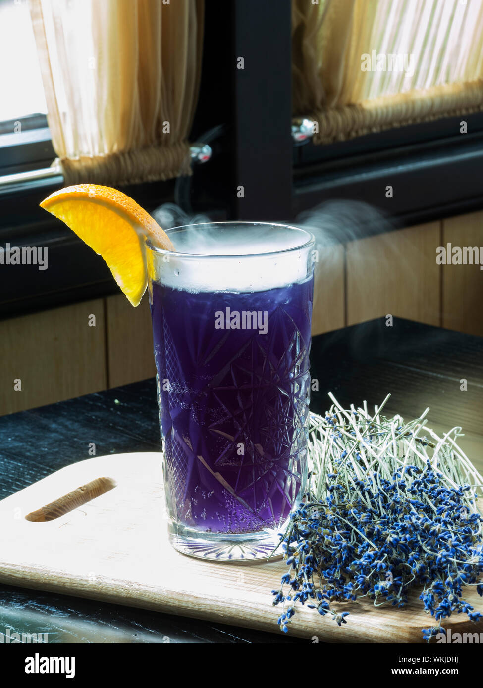 Close-up Of Vapor On Lavender Lemonade At Table By Window Stock Photo