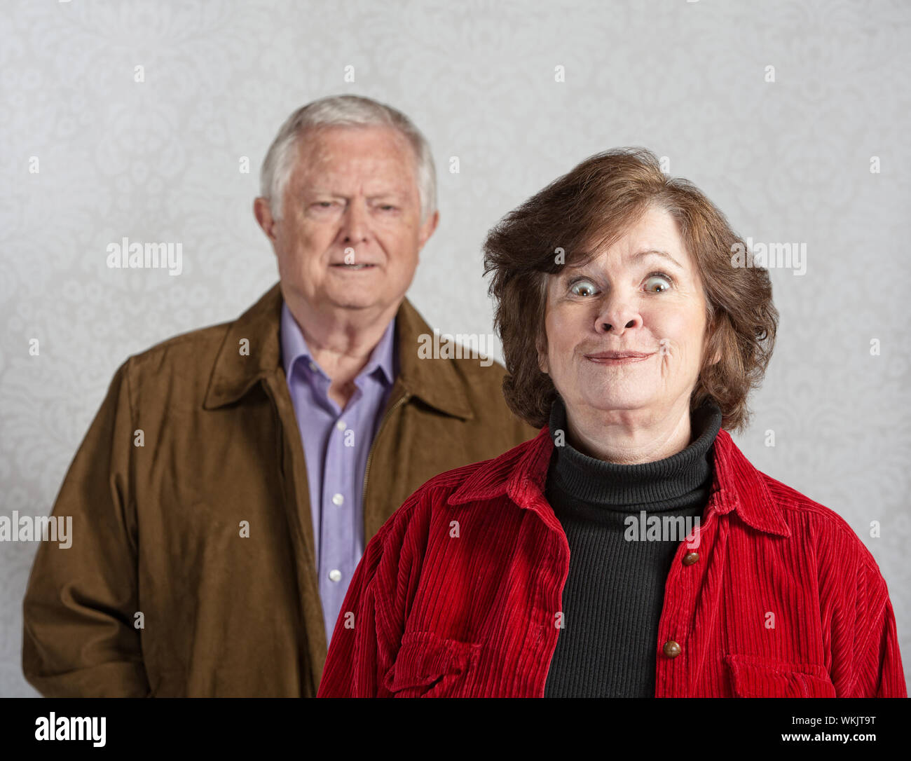 Funny senior European woman teasing confused man Stock Photo