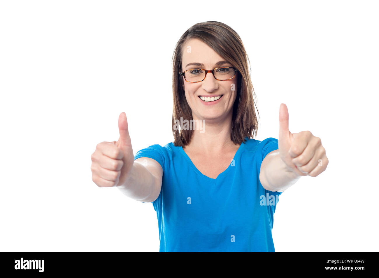 Happy woman gesturing double thumbs up Stock Photo - Alamy