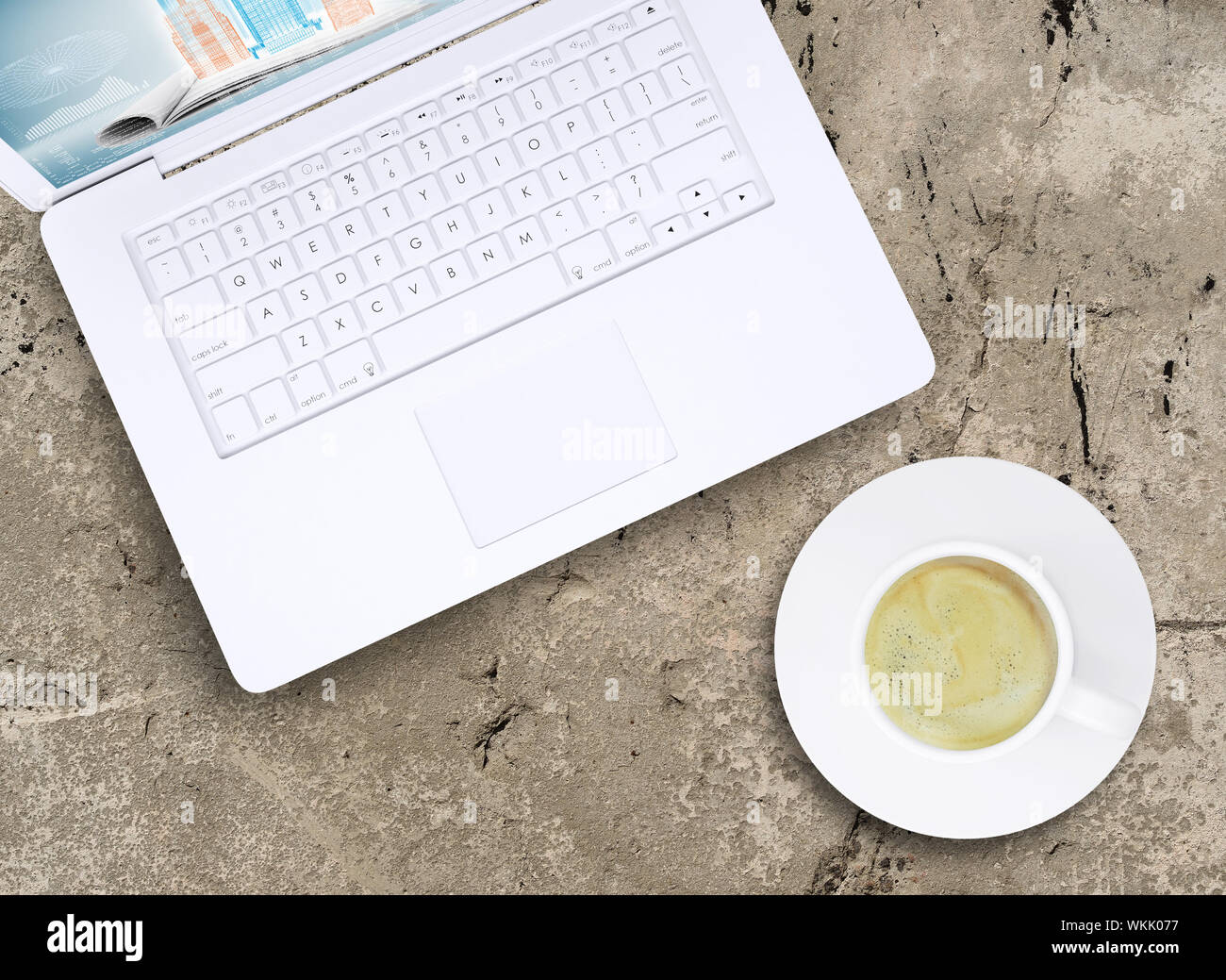 Laptop and a cup of coffee with crema on old concrete surface. Computer ...