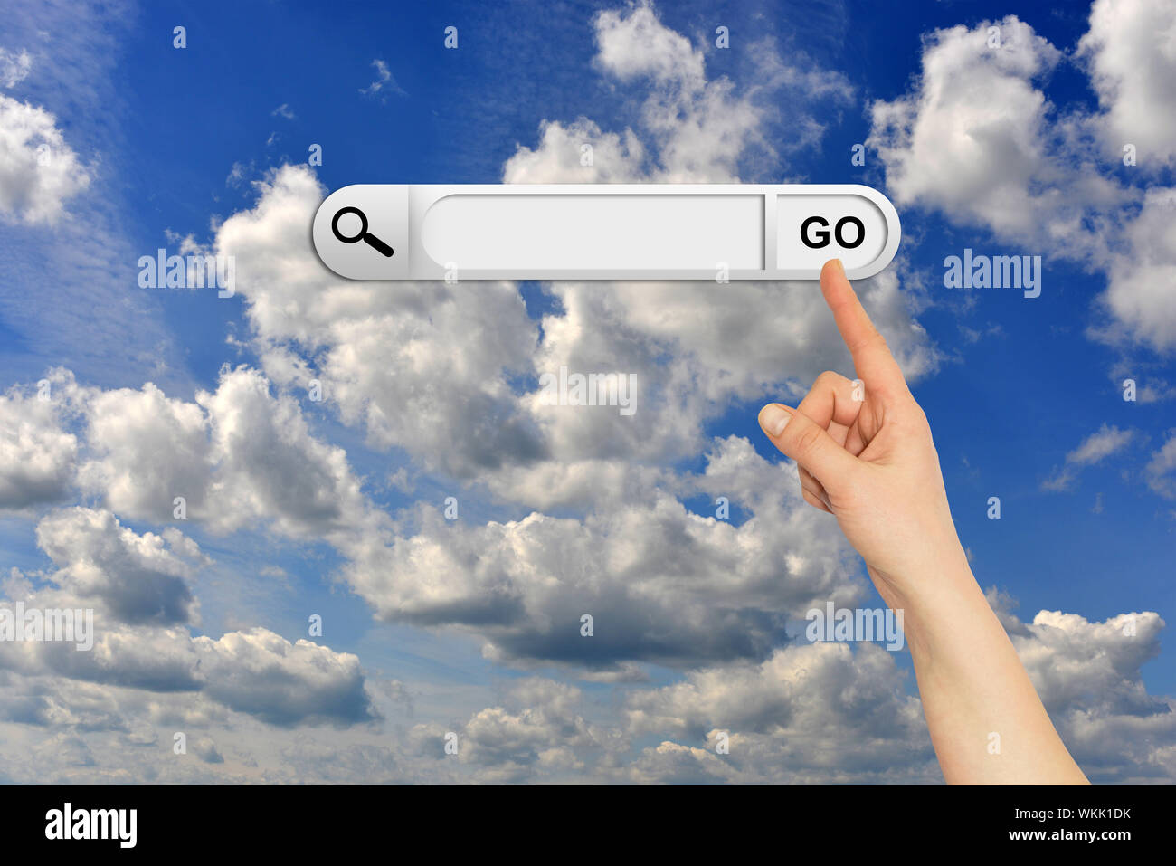 Human hand indicates the search bar in browser. Blue sky and clouds on