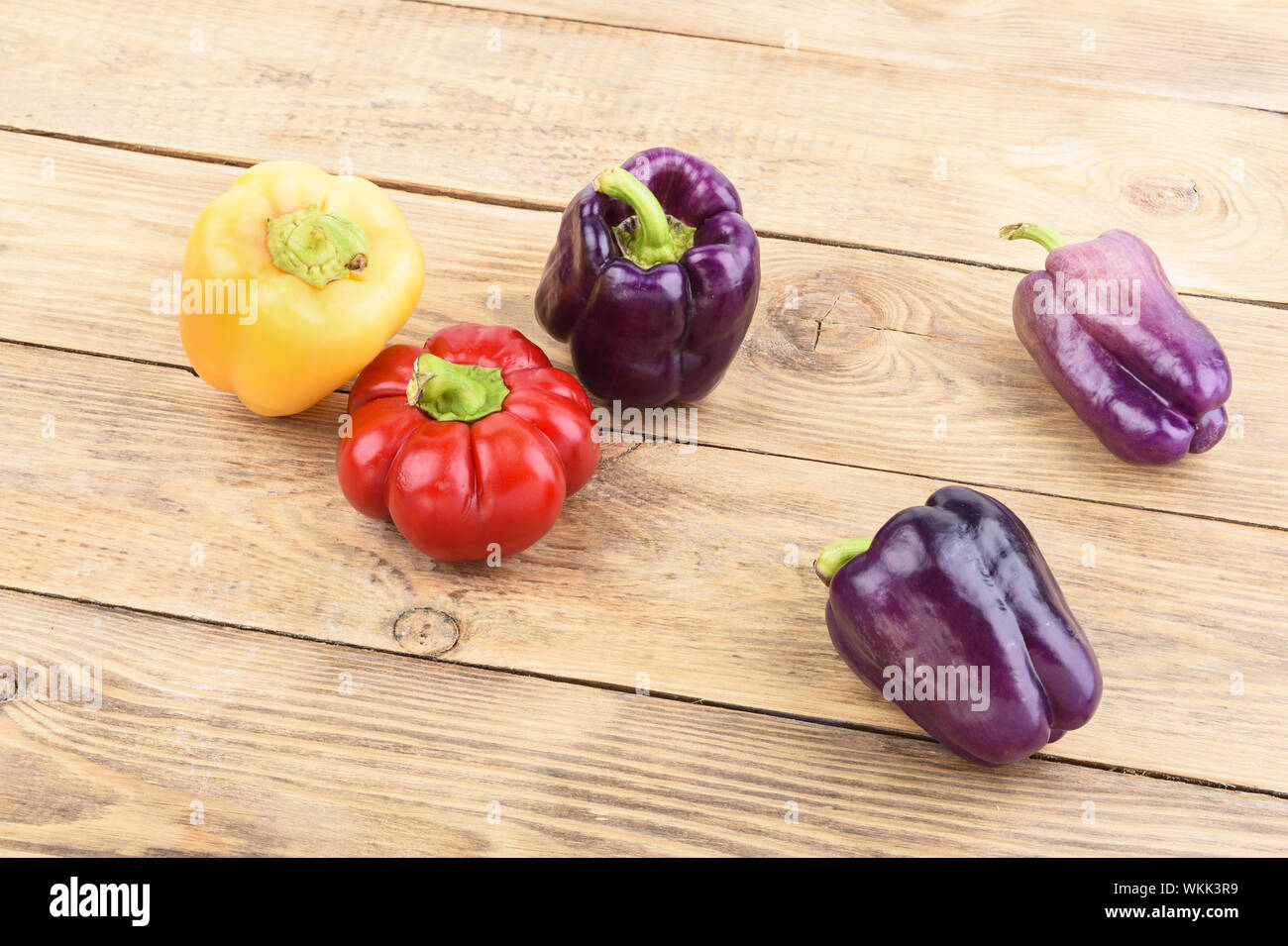 Colorful fresh bell peppers on a wooden table. Rustic style Stock Photo ...