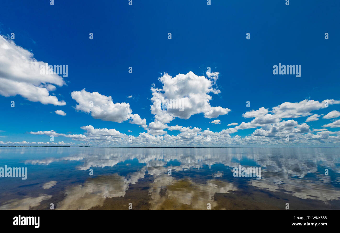 White cloud reflections in Sarasota Bay from Longboat Key in southwestern Florida Stock Photo