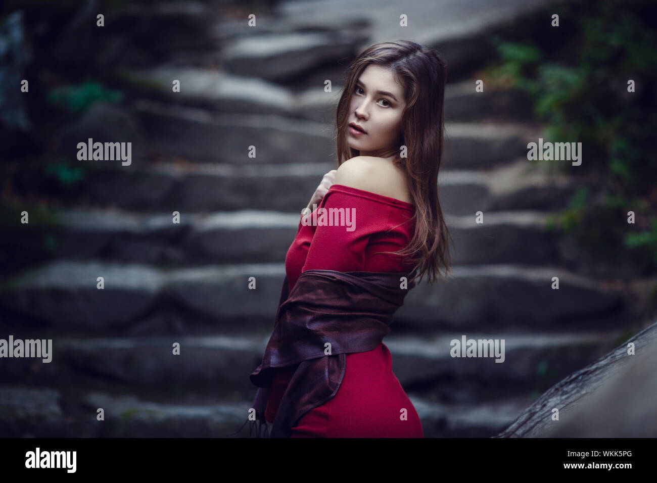Beautiful girl in a red dress, long dark hair and with Asian appearance ...