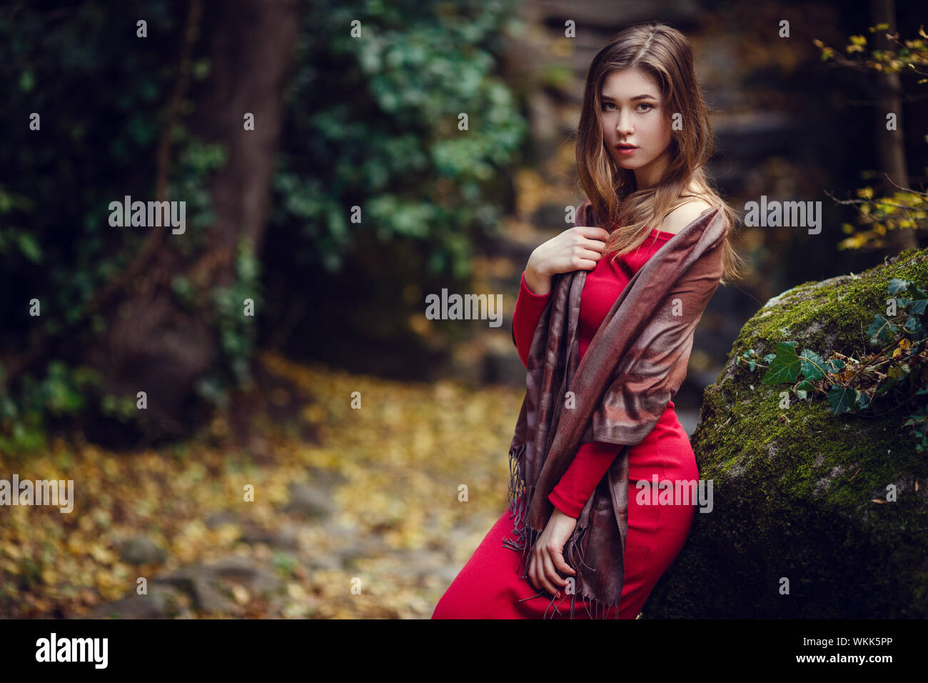 Beautiful girl in a red dress, long dark hair and with Asian appearance ...