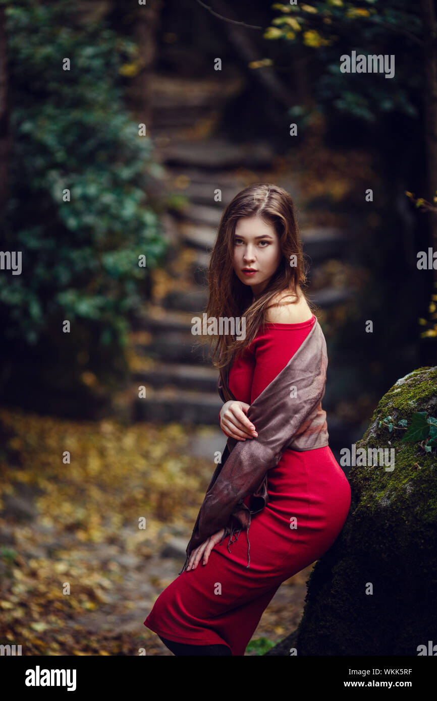 Beautiful girl in a red dress, long dark hair and with Asian appearance ...