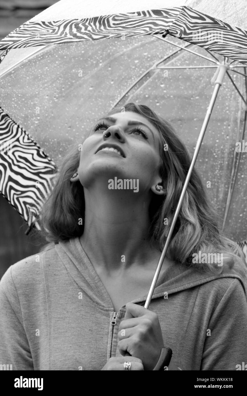 Woman standing in rain umbrella Black and White Stock Photos & Images Alamy