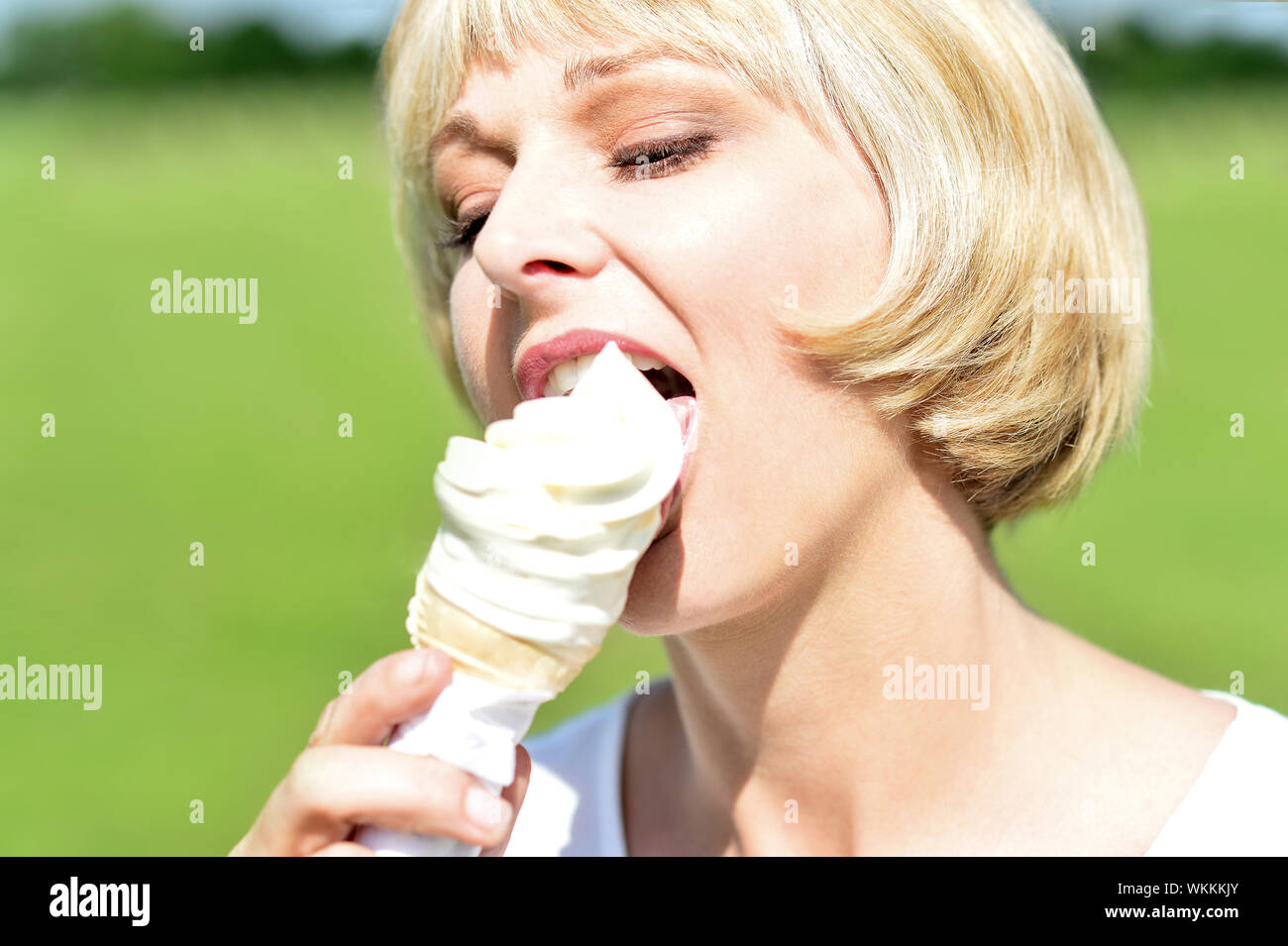Beautiful woman licking an ice cream Stock Photo Alamy