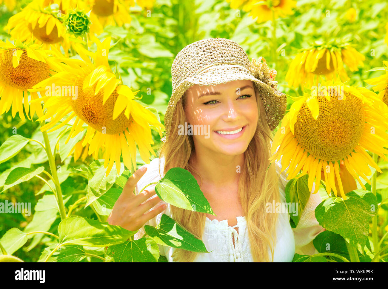 Cute girl in sunflower field Stock Photo - Alamy