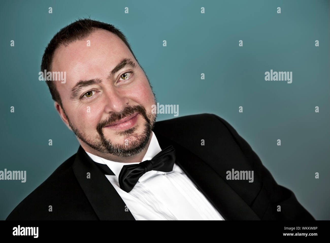 A handsome man with a goatee beard in a black suit Stock Photo Alamy