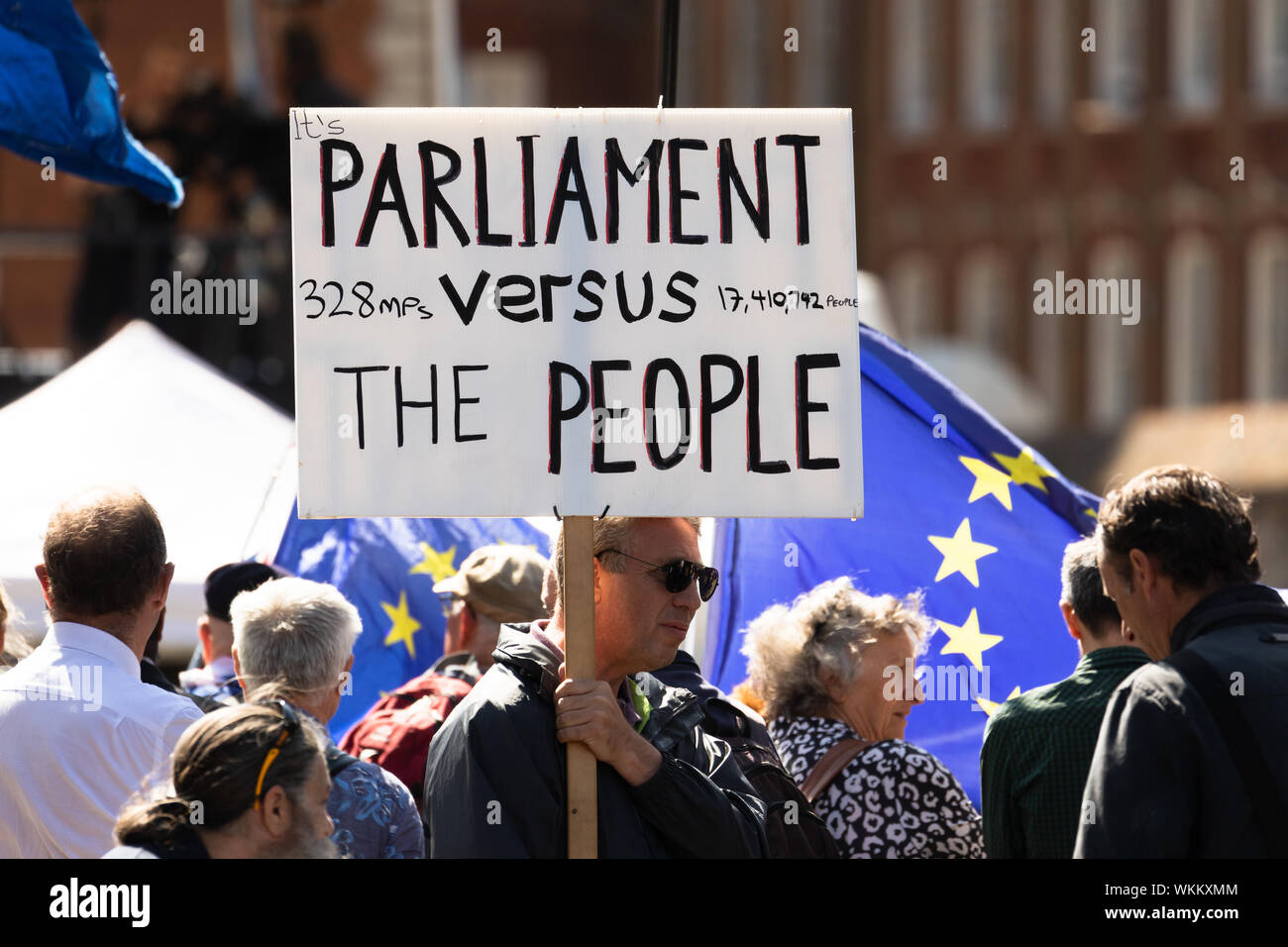 London, UK. 4th September 2019. A pro Brexit protester with a placard walks past pro remain protesters in Westminster. Today Members of Parliament (MP's) will vote on whether to block a no deal Brexit and hold a general election. Credit: London Pix/Alamy Live News Stock Photo