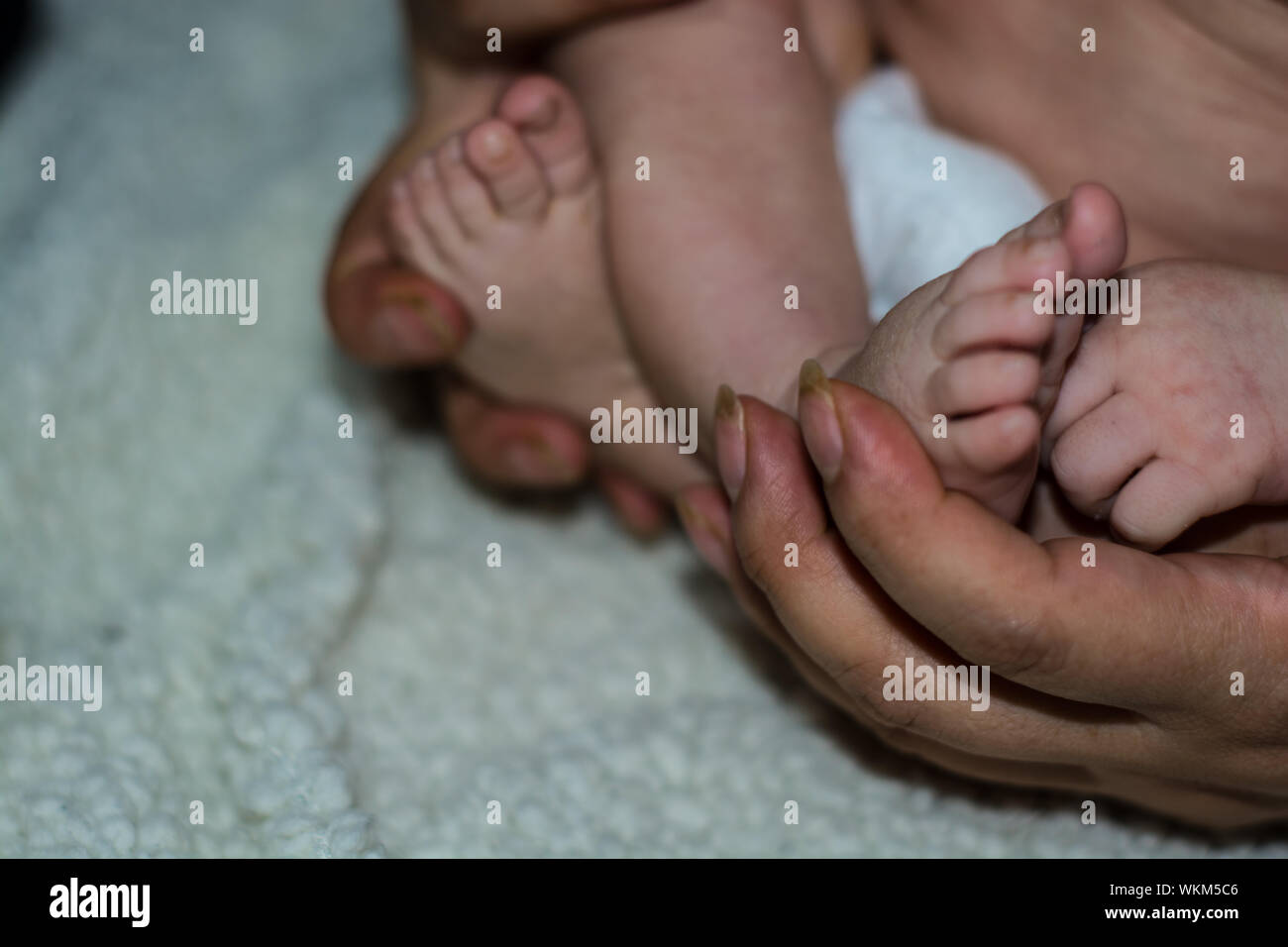 Baby feet parents hands hires stock photography and images Alamy