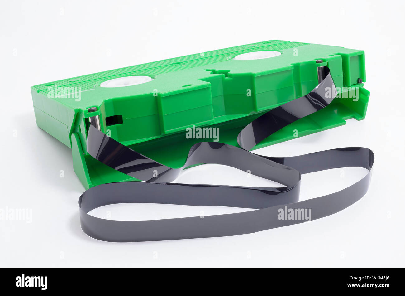 VHS tape with open cover and the tape rolled out of the spool